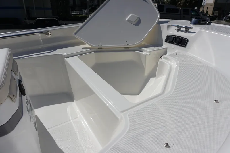 Slide: The Image of 2025 Boston Whaler 150 Montauk boat interior with open storage compartment. - 10