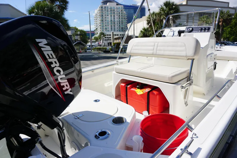 Slide: The Image of 2025 Boston Whaler 150 Montauk boat interior with Mercury engine and seating. - 15