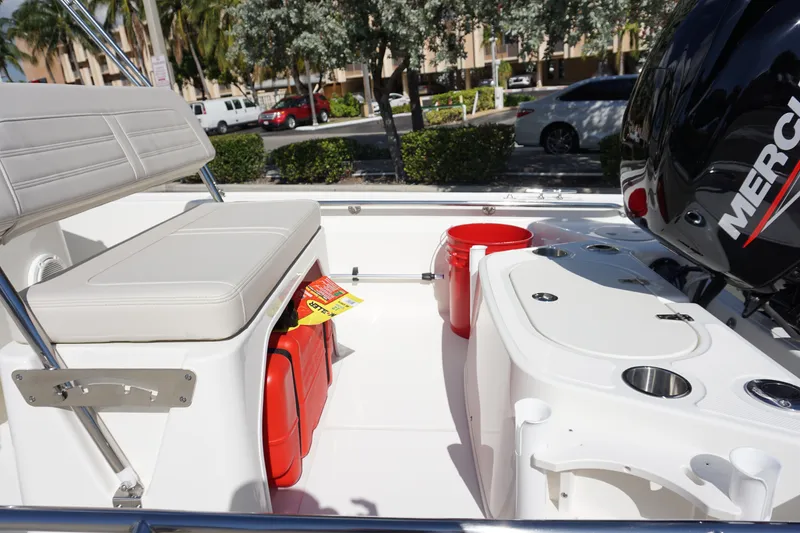 Slide: The Image of 2025 Boston Whaler 150 Montauk interior with seating and Mercury engine. - 17