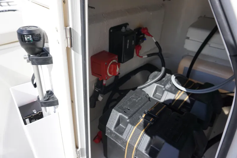 Slide: The Image of 2025 Boston Whaler 150 Montauk battery compartment with wiring and components. - 20
