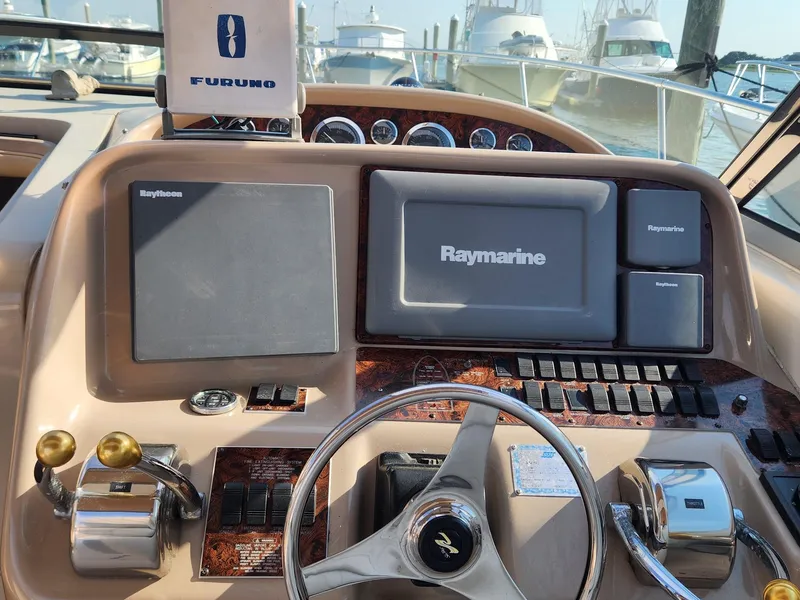 Slide: The Image of Cockpit of 2000 Sea Ray 370 Express Cruiser with navigation equipment and steering wheel. - 10