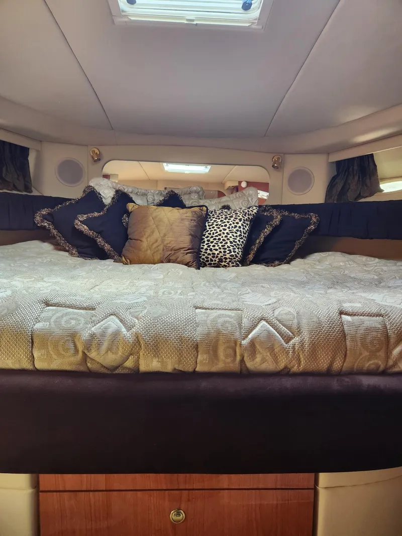 Slide: The Image of Luxurious cabin interior of 2000 Sea Ray 370 Express Cruiser with plush bedding. - 15