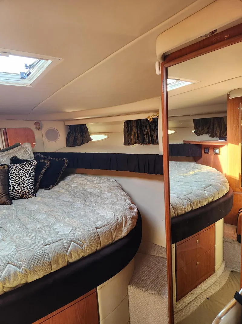 Slide: The Image of Interior cabin of 2000 Sea Ray 370 Express Cruiser with cozy bed and pillows. - 16