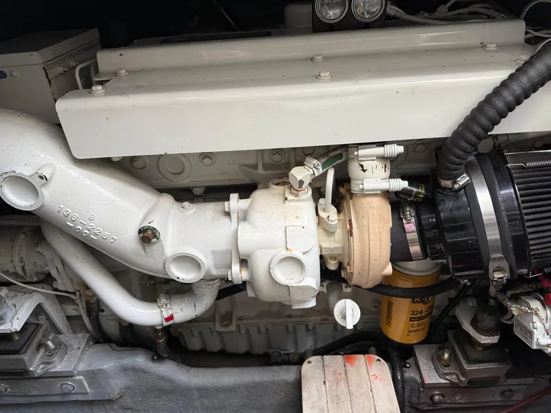 Slide: The Image of Engine compartment of a 2000 Sea Ray 370 Express Cruiser, showcasing mechanical components. - 21