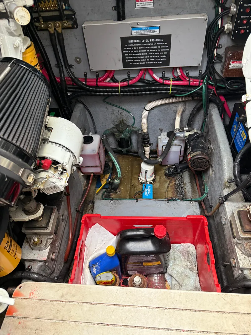 Slide: The Image of Engine compartment of 2000 Sea Ray 370 Express Cruiser with maintenance supplies. - 22