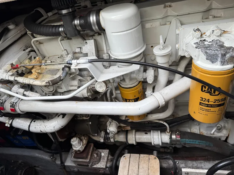 Slide: The Image of Engine compartment of 2000 Sea Ray 370 Express Cruiser with CAT oil filters. - 23