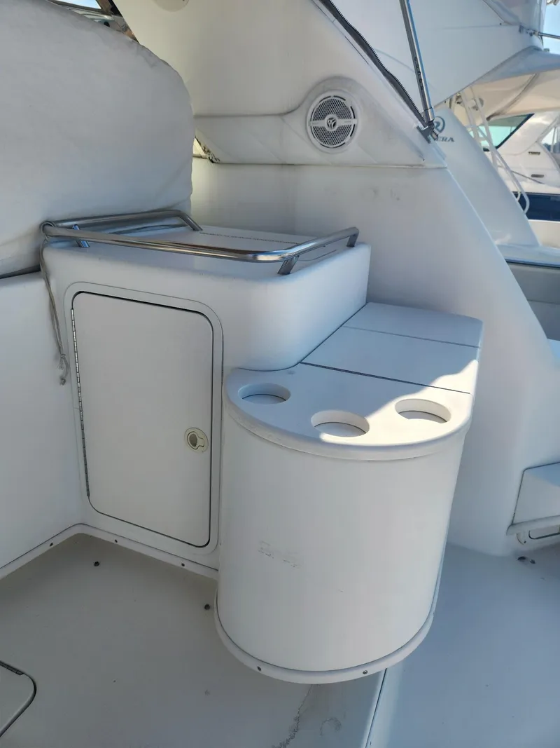Slide: The Image of 2000 Sea Ray 370 Express Cruiser interior with storage and cup holders. - 6