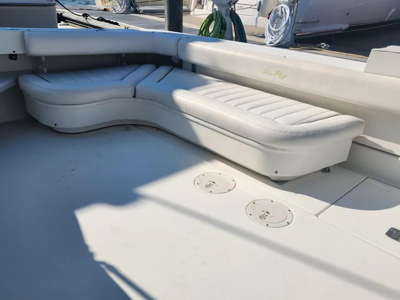 Slide: The Image of 2000 Sea Ray 370 Express Cruiser with white cushioned seating on deck. - 7