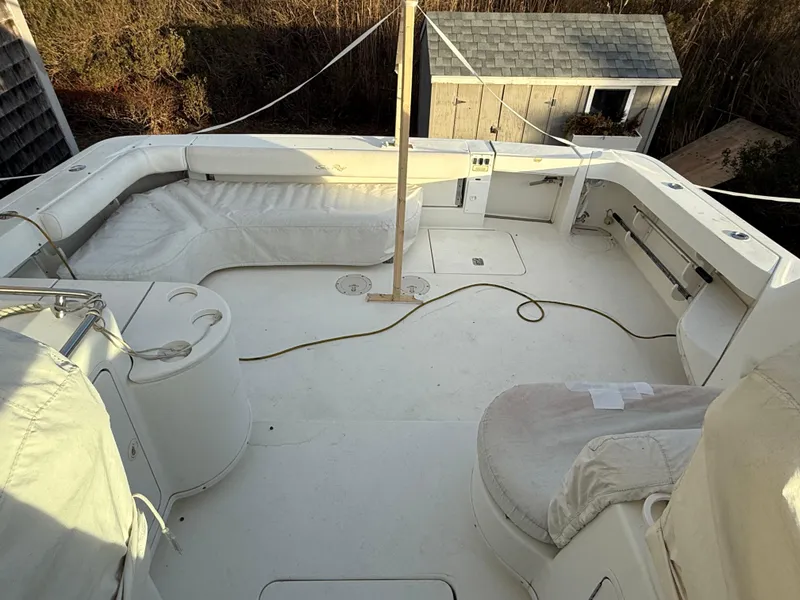 Slide: The Image of 2000 Sea Ray 370 Express Cruiser deck with seating and storage. - 8
