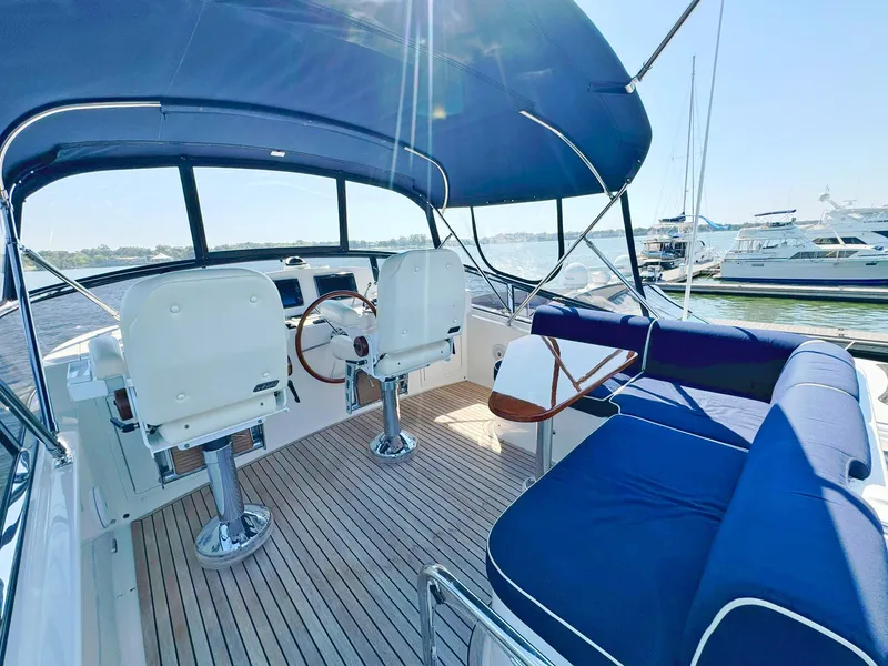 Slide: The Image of Flybridge of 2014 Grand Banks 46 Eastbay FB with blue seating and helm chairs. - 23