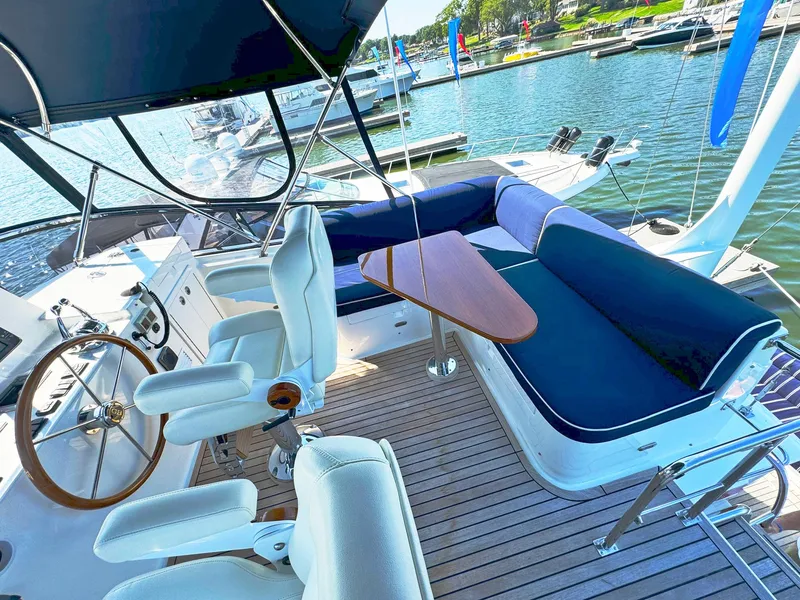 Slide: The Image of Flybridge of 2014 Grand Banks 46 Eastbay FB yacht with seating and helm, docked at marina. - 24