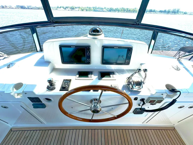 Slide: The Image of Helm of 2014 Grand Banks 46 Eastbay FB yacht with dual screens and wooden steering wheel. - 26