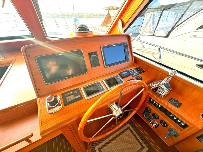 Slide: The Image of Helm of 2014 Grand Banks 46 Eastbay FB with navigation instruments and wooden steering wheel. - 35