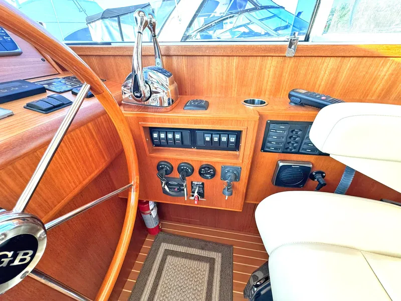 Slide: The Image of Helm of 2014 Grand Banks 46 Eastbay FB with wooden finish and control panel. - 36
