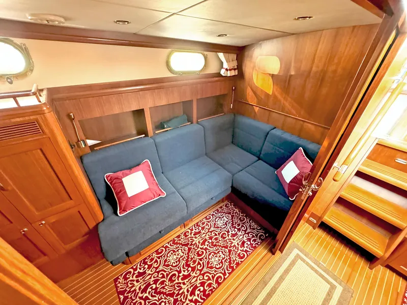 Slide: The Image of Luxurious 2014 Grand Banks 46 Eastbay FB yacht interior with blue seating and elegant wood finish. - 40
