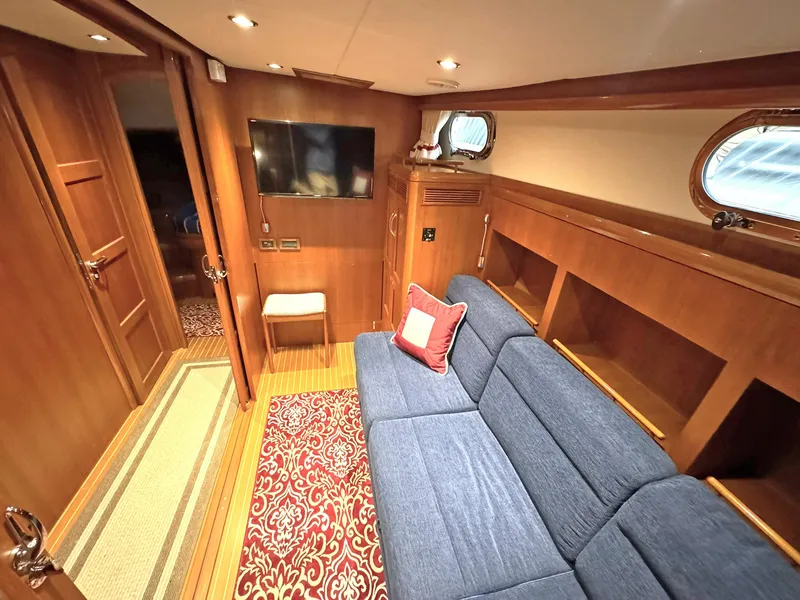Slide: The Image of Luxurious 2014 Grand Banks 46 Eastbay FB interior with blue sofa, TV, and elegant wood finish. - 41