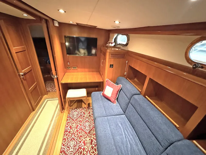 Slide: The Image of Luxurious interior of 2014 Grand Banks 46 Eastbay FB yacht with blue sofa and TV. - 42