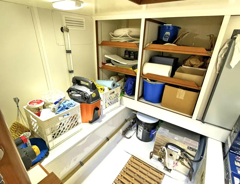 Slide: The Image of Storage area on 2014 Grand Banks 46 Eastbay FB, featuring shelves and cleaning supplies. - 46