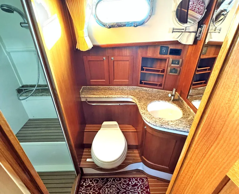 Slide: The Image of Luxurious 2014 Grand Banks 46 Eastbay FB yacht bathroom with wood accents and granite countertop. - 47