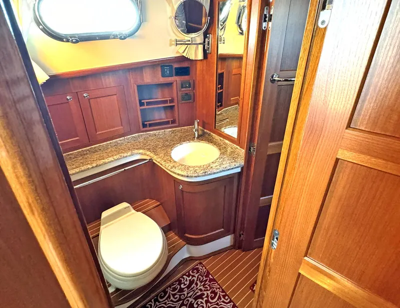 Slide: The Image of Luxurious bathroom in 2014 Grand Banks 46 Eastbay FB yacht with wooden cabinetry. - 48