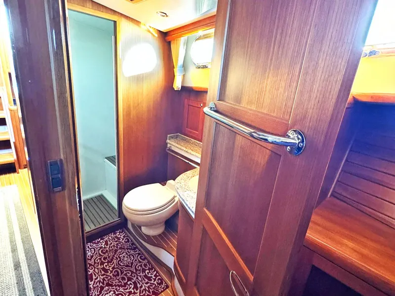 Slide: The Image of Luxurious 2014 Grand Banks 46 Eastbay FB yacht bathroom with wood finish and modern amenities. - 49