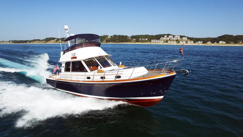 Slide: The Image of Grand Banks 46 Eastbay FB 2014 cruising on open water, showcasing sleek design and performance. - 7