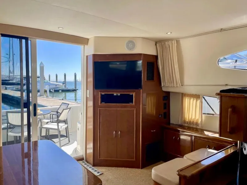 Slide: The Image of Interior of 2007 Carver 35 Super Sport yacht with marina view through sliding doors. - 23