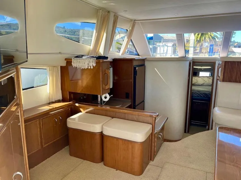 Slide: The Image of Interior of 2007 Carver 35 Super Sport yacht with elegant wood finishes and seating. - 25