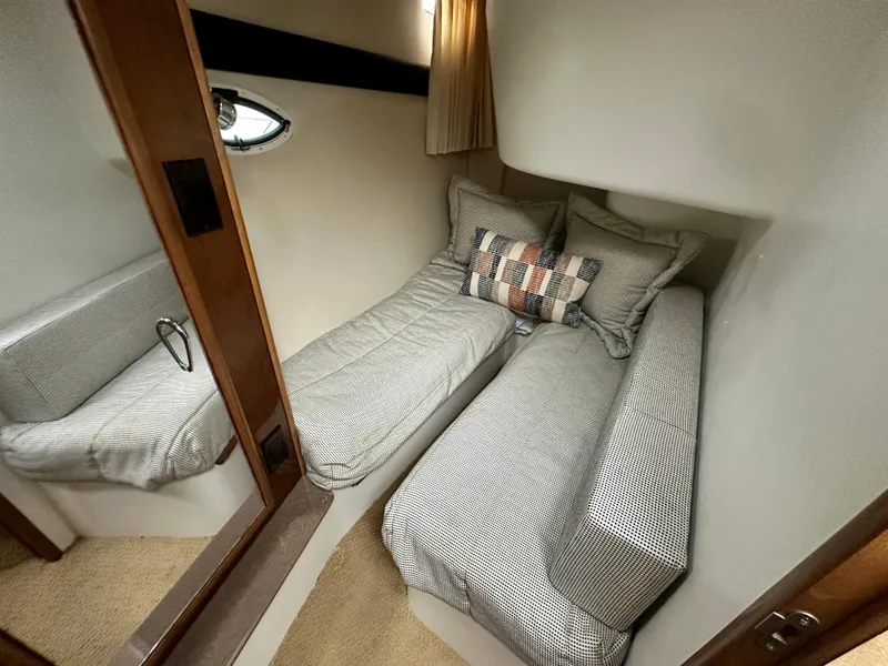 Slide: The Image of 2007 Carver 35 Super Sport cabin with twin beds and decorative pillows. - 31