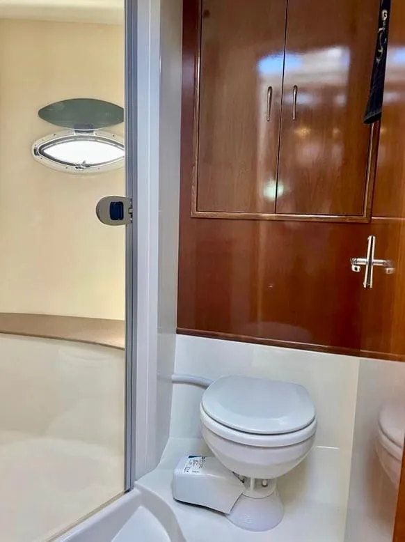 Slide: The Image of 2007 Carver 35 Super Sport bathroom with wooden cabinets and modern fixtures. - 36