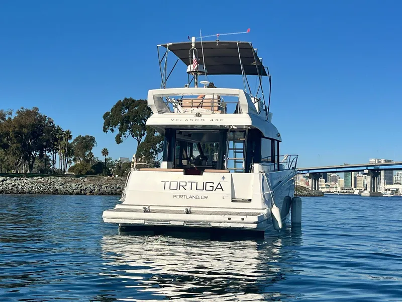 Slide: The Image of 2017 Jeanneau Velasco 43F yacht on calm water, clear sky, and scenic background. - 10