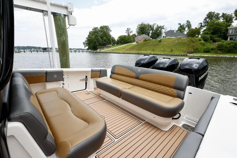 Slide: The Image of 2020 Fountain 39 NX boat interior with luxurious seating and scenic waterfront view. - 10