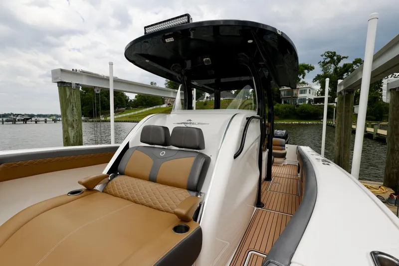 Slide: The Image of 2020 Fountain 39 NX boat with luxurious seating, docked by a scenic waterfront. - 11