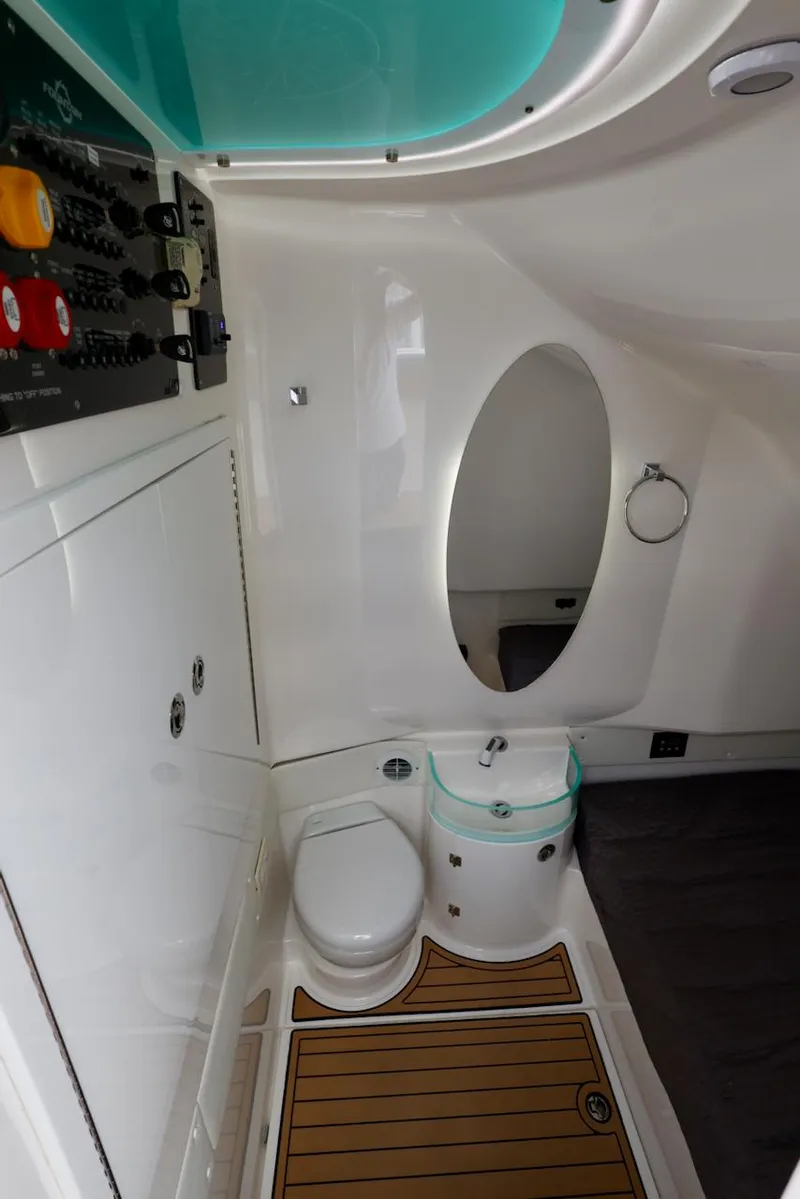 Slide: The Image of 2020 Fountain 39 NX boat interior bathroom with modern fixtures and wood-style flooring. - 12