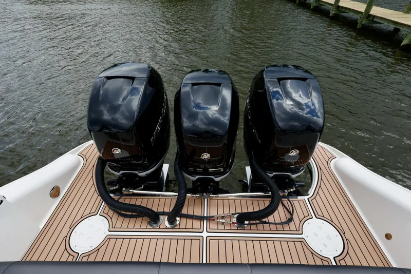 Slide: The Image of 2020 Fountain 39 NX boat with triple outboard engines on teak deck. - 14