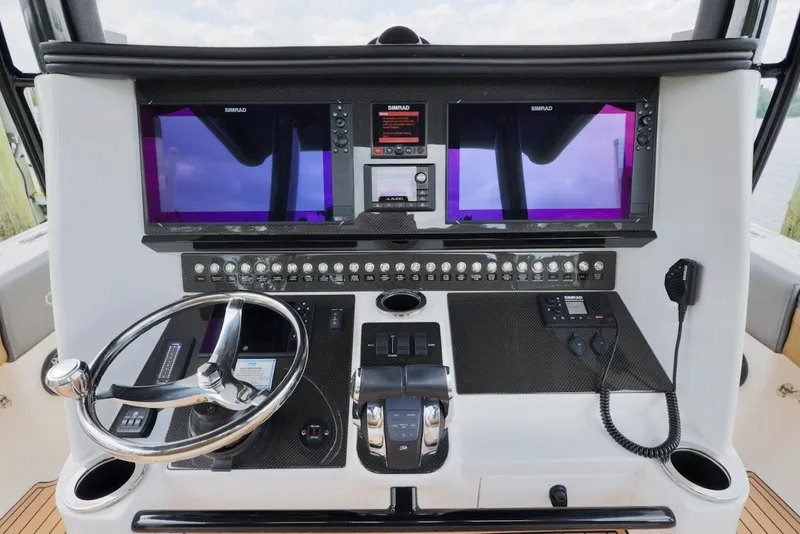 Slide: The Image of 2020 Fountain 39 NX boat dashboard with dual screens and steering wheel. - 15