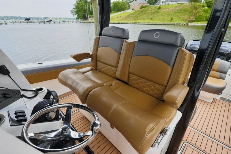 Slide: The Image of 2020 Fountain 39 NX boat interior with tan leather seats and steering wheel. - 16