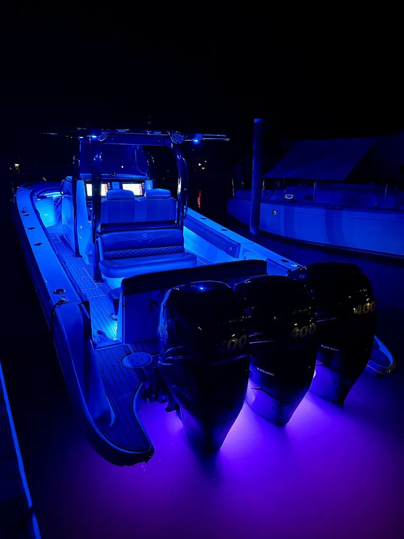 Slide: The Image of 2020 Fountain 39 NX boat with blue LED lights at night. - 18