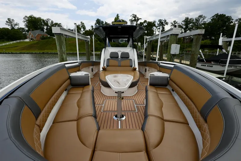 Slide: The Image of 2020 Fountain 39 NX boat with luxurious tan seating and sleek design at a dock. - 5