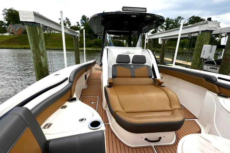 Slide: The Image of 2020 Fountain 39 NX boat interior with luxurious seating and sleek design at a dock. - 6