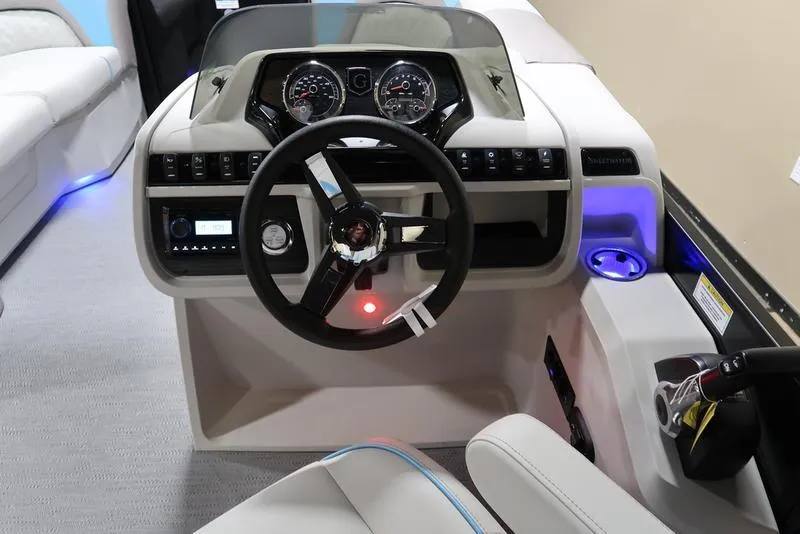Slide: The Image of 2025 Sweetwater SW 2286 QS boat dashboard with steering wheel and modern controls. - 19