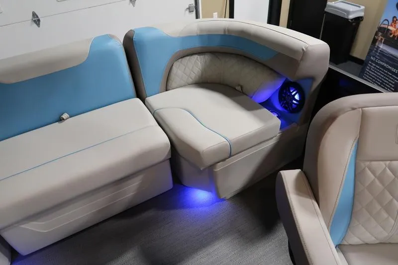 Slide: The Image of 2025 Sweetwater SW 2286 QS boat interior with blue LED lighting and beige seating. - 21