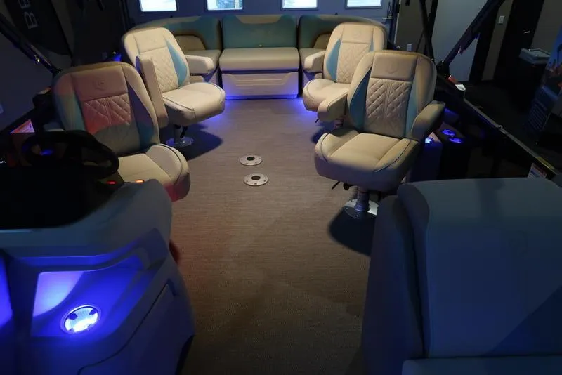 Slide: The Image of Luxurious interior of 2025 Sweetwater SW 2286 QS pontoon boat with ambient blue lighting. - 25