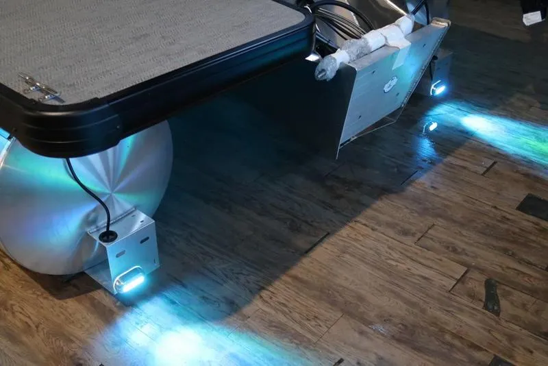 Slide: The Image of 2025 Sweetwater SW 2286 QS pontoon boat with underwater LED lights on wooden floor. - 28