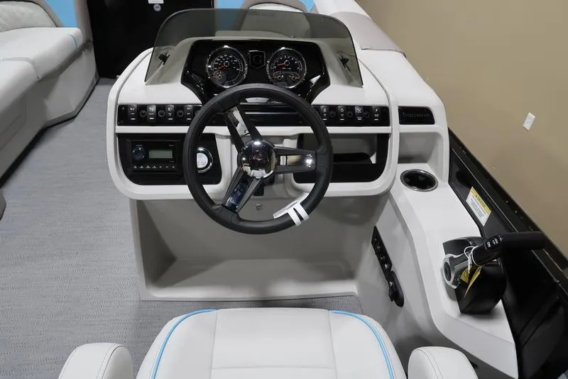 Slide: The Image of 2025 Sweetwater SW 2286 QS boat dashboard with steering wheel and control panel. - 33