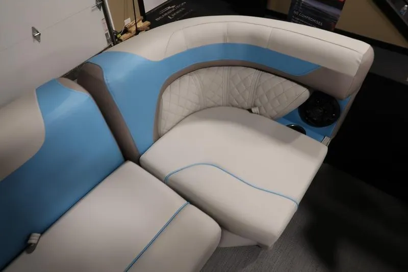 Slide: The Image of Luxurious seating in 2025 Sweetwater SW 2286 QS boat with blue and white upholstery. - 37