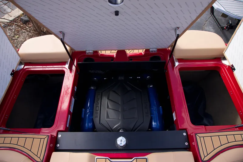 Slide: The Image of 2025 MasterCraft XT22T boat engine compartment with open storage hatches. - 10