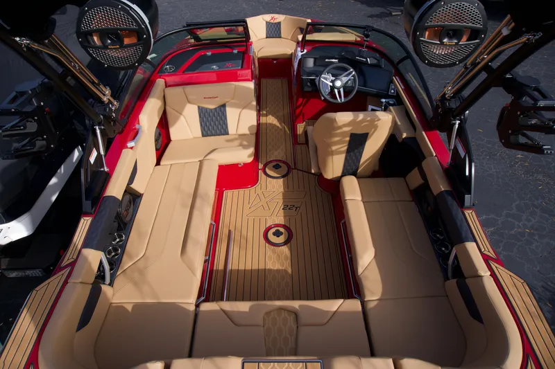 Slide: The Image of 2025 MasterCraft XT22T boat interior with tan seating and modern dashboard. - 4