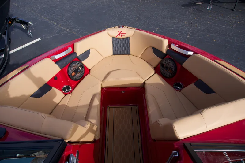 Slide: The Image of 2025 MasterCraft XT22T boat interior with tan and red seating, premium design. - 5