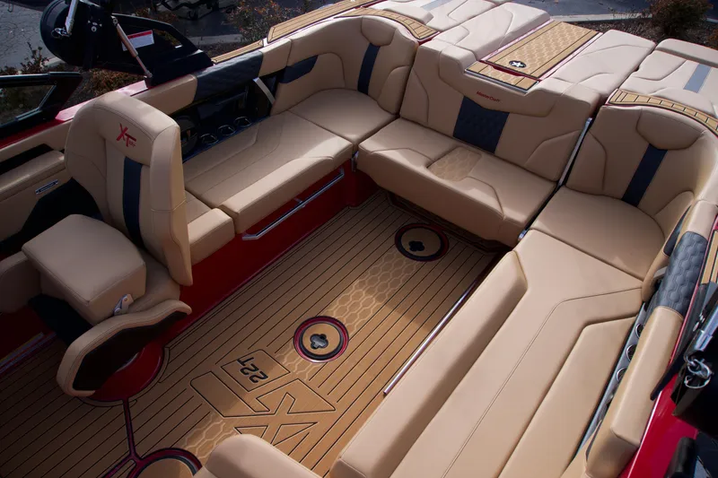 Slide: The Image of Luxurious interior of 2025 MasterCraft XT22T boat with beige seating and wood flooring. - 7